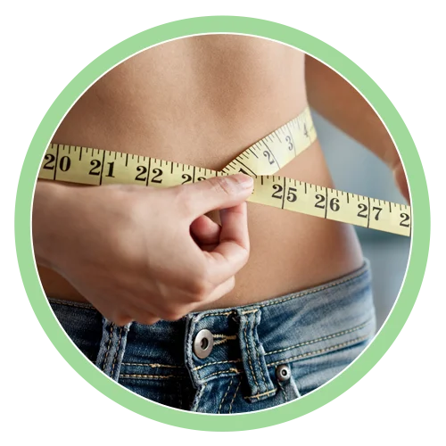 Weight Loss Pomona CA Measuring Waist HP v2 A woman using a measuring tape to measure her weight loss progress around her waist